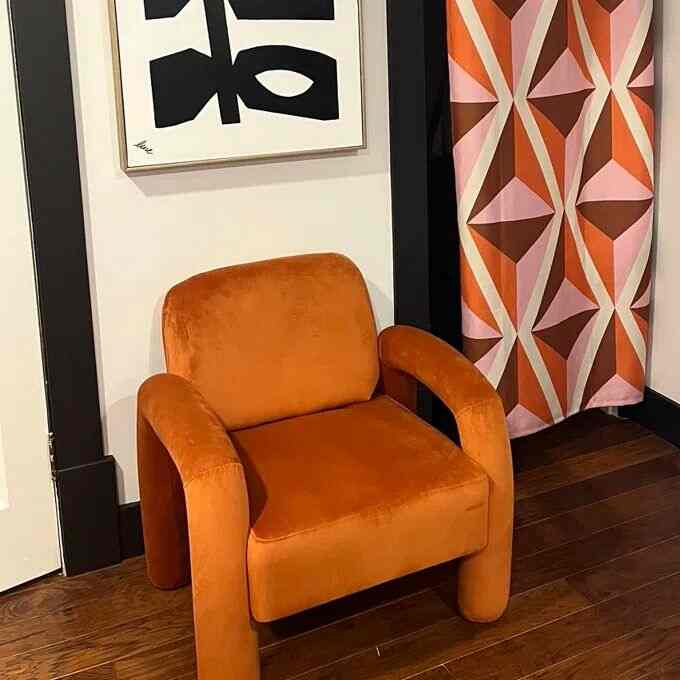Feeling all the warm vibes with this orange lounge chair and matching curtains 🍊✨ A pop of color that brings joy to my space! 
#ColorPop #HomeVibes #VelvetChair #MidCenturyModern #GeometricArt