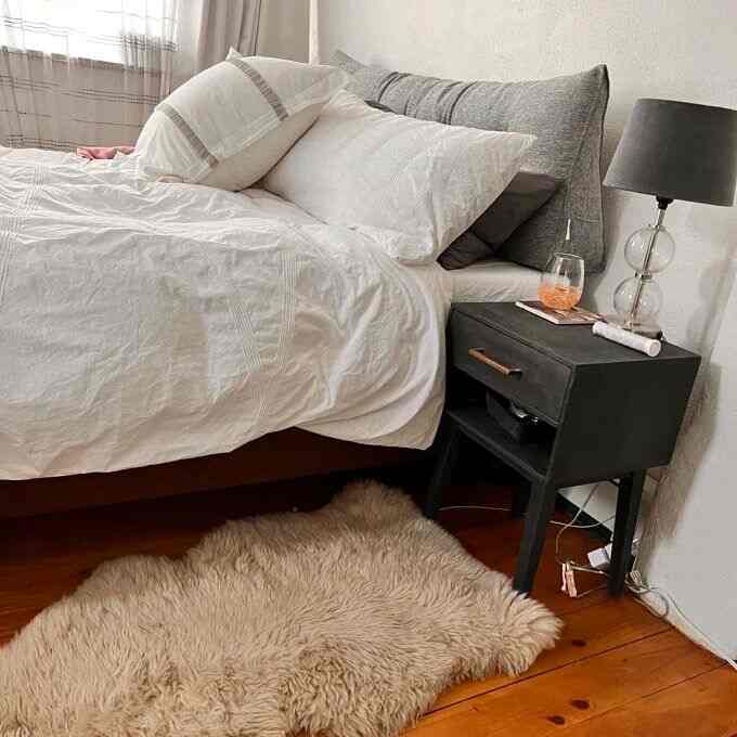 Stepping into comfort with this fluffy area rug by the bed! 🛏️✨ Perfect for adding warmth and coziness to my space. #HomeSweetHome #CozyVibes #BedsideTable #SheepskinRug #CozyInterior