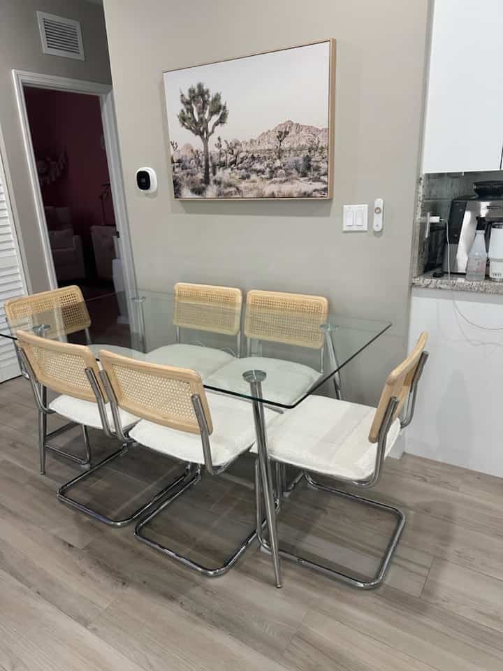 Elevating my dining experience with this sleek glass table and beautiful white rattan chairs! Perfectly light and airy ✨🤍 #DiningInStyle #RattanChic #HomeDecor #GlassTable #CaneChairs #ModernDecor