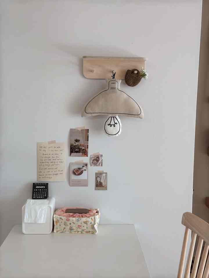 白と木目調のシンプルなテーブルと椅子が配置された、雰囲気のある壁面インテリア