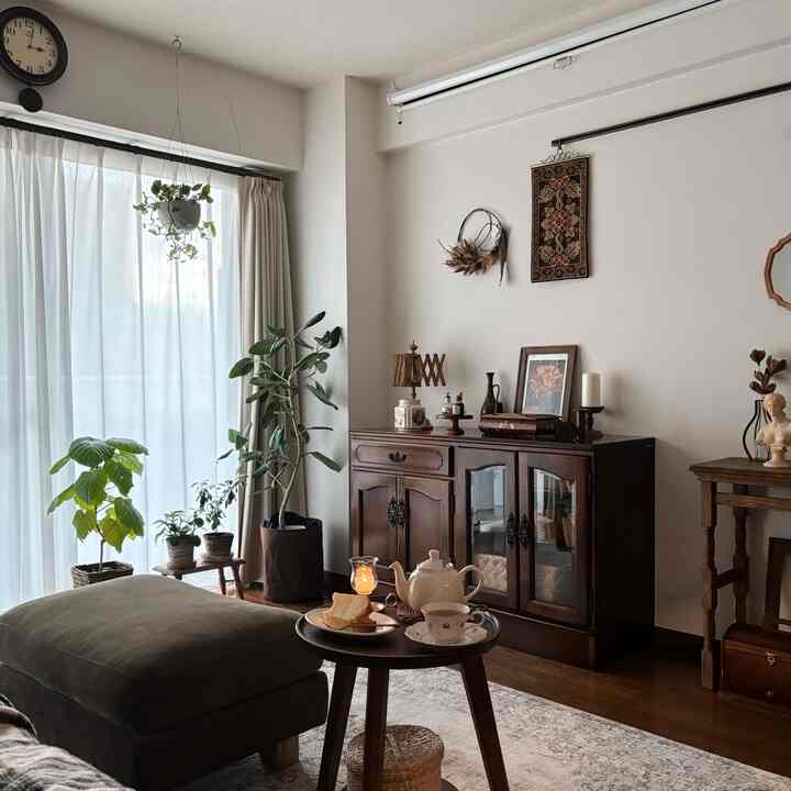 Natural white-toned living room featuring wood furniture and plants in a harmonious vintage style