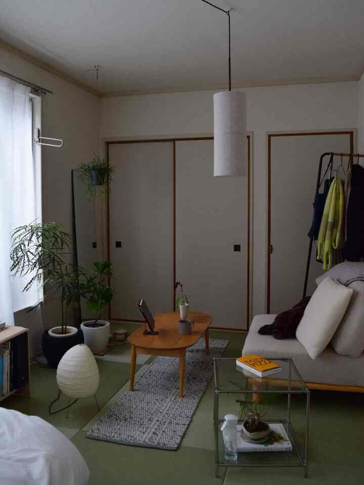 Natural tones and green tatami flooring living room featuring sofa and wooden coffee table in a natural modern interior