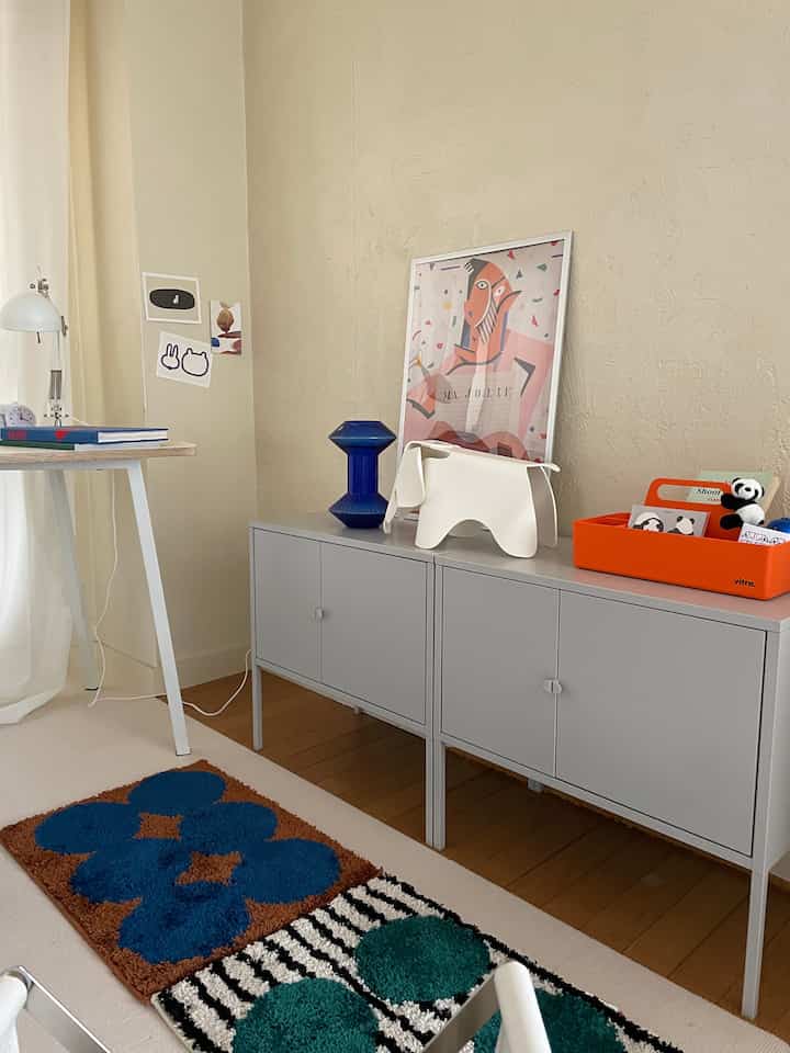 White and gray toned 1DK living room featuring a cabinet and colorful rugs in a modern Nordic style space