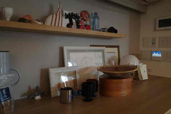 Natural wood tones cafe-style storage space featuring various objet decor