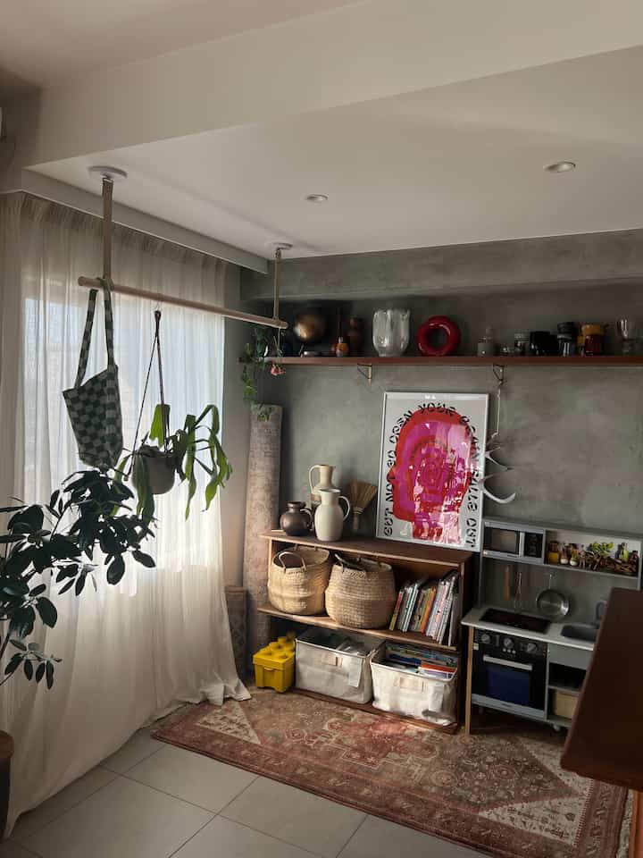 Mid-Century Modern kids' space with wood-toned storage and plants bathed in soft natural light