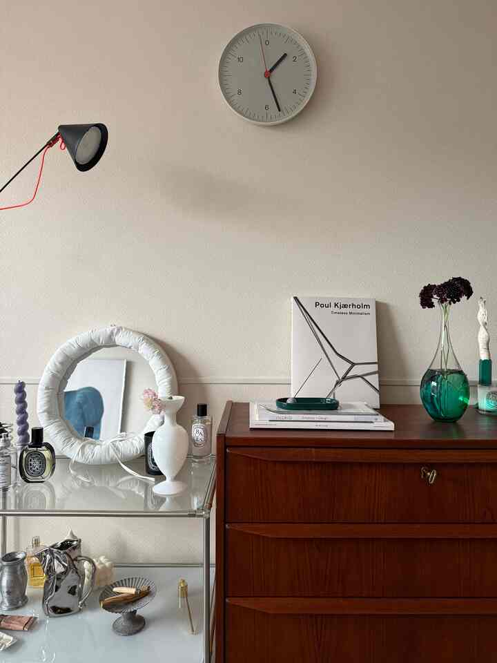 White walls and vintage wooden dresser in a mid-century modern living room interior