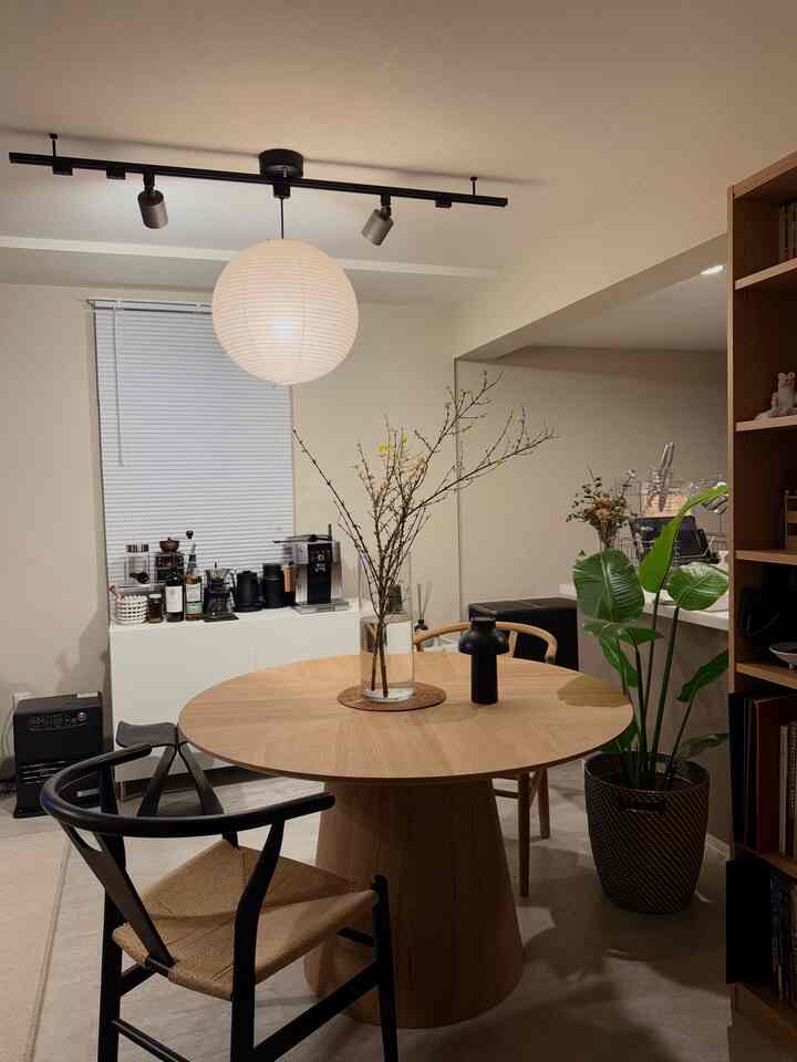 Natural wood tone and white two-person dining room featuring minimalistic Japandi style with calm atmosphere