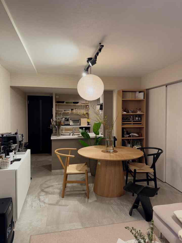 Natural-toned and white-walled two-person dining room featuring a round dining table and pendant light in a Japandi and Wa-Modern style interior
