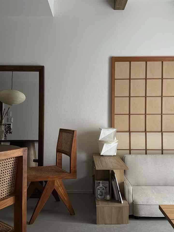 Bright white and brown wood tone living room featuring Wa-Modern style sofa and grid wall creating a modern natural ambiance