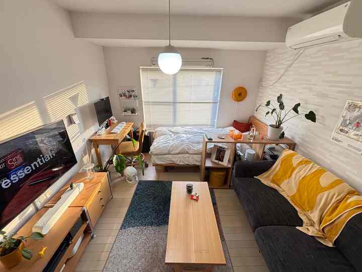 Natural color toned 1K single household room featuring wood furniture and sofa with cozy atmosphere