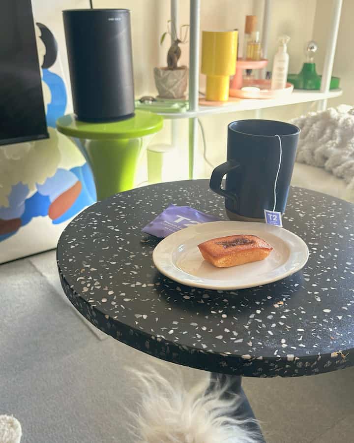 Modern natural-tone single household 8-tatami room featuring a black speckled tray table with a mini plate and mug cup for a cozy home cafe setup