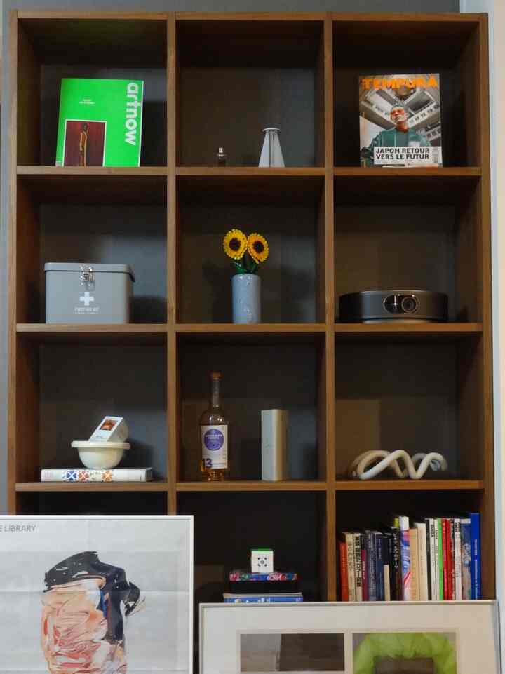 Wood tone shelving featuring assorted art pieces and accessories in a simple Nordic style interior