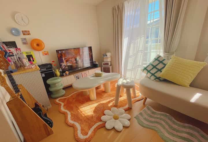 Bright vitamin color living room featuring an orange rug and mid-century modern furniture with cozy atmosphere