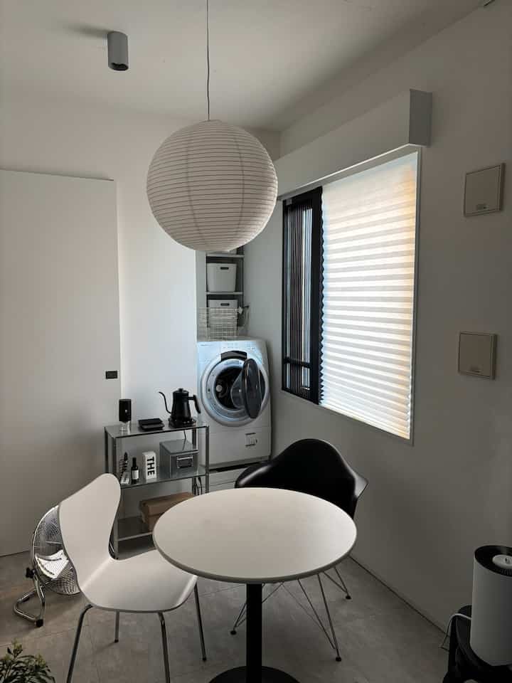 White and black toned small home cafe space featuring simple modern interior with Hyllis shelf unit