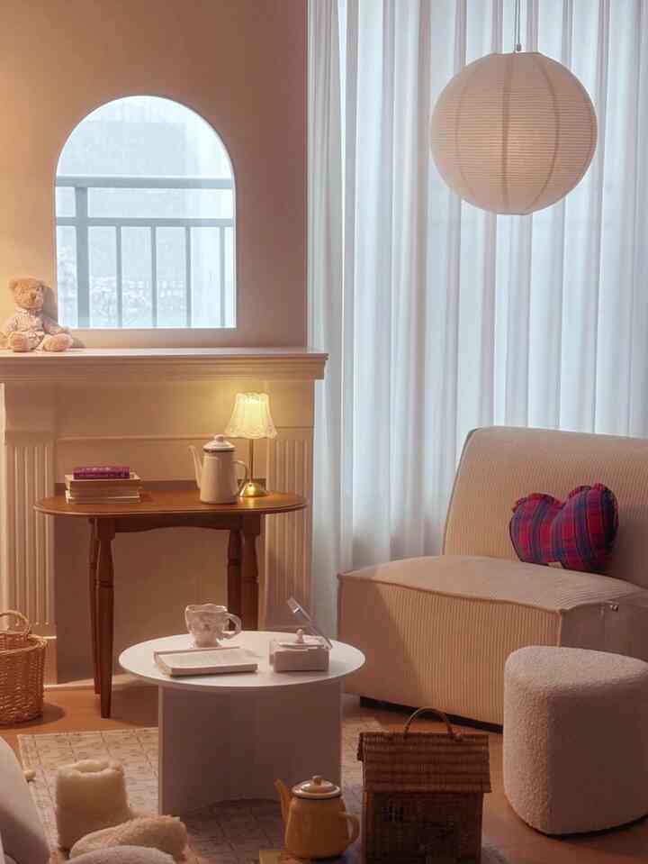 A cozy living room with white curtains and brown wood-tone furniture featuring vintage accents