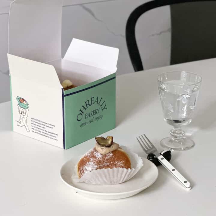 Simple and natural home cafe space featuring a glass and plate on a white table