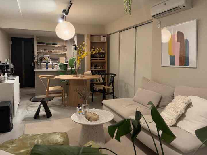 Soft beige and wood-tone living and dining room featuring a cozy modern interior style