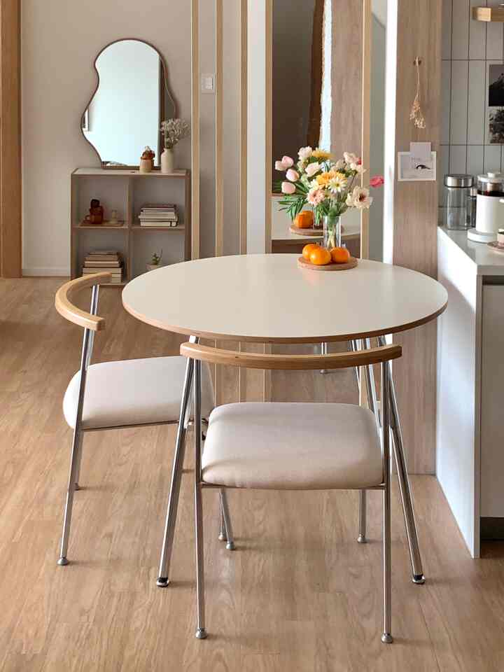 White and wood-toned dining room featuring oval dining table and chairs with a cozy, natural atmosphere