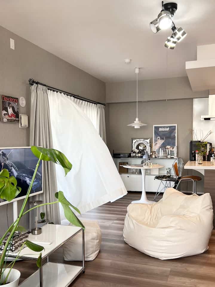 Beige and white toned living room featuring bean bag sofa and plants with a modern and natural atmosphere