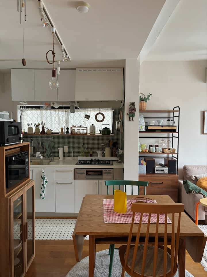 ナチュラルな木目調と白を基調とした一人暮らし向けのキッチン・リビング、自然光が溢れ落ちる暖かみのあるインテリア