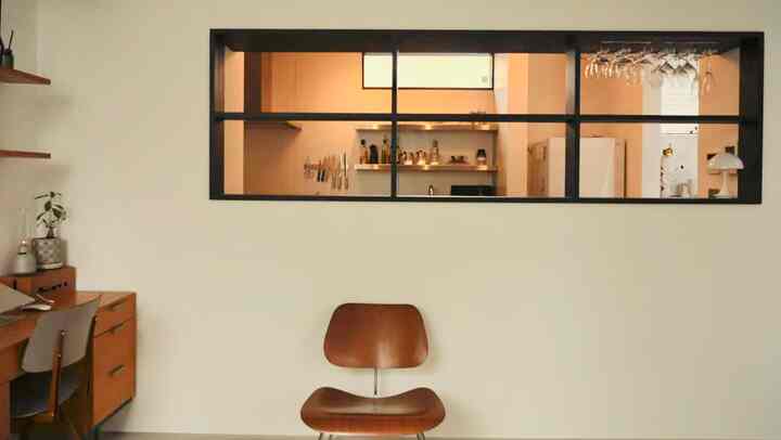 Modern two-person living and kitchen space featuring ivory walls and brown furniture blending harmoniously