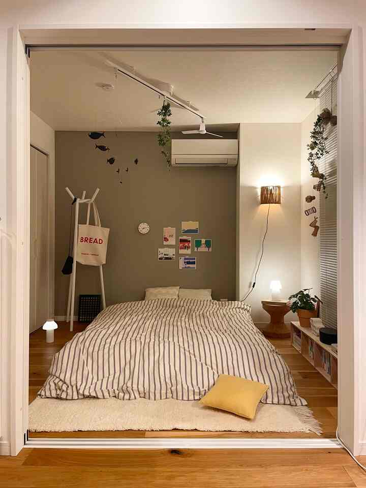 Natural-toned bedroom featuring portable lights and wooden furniture creating a cozy and comfortable atmosphere