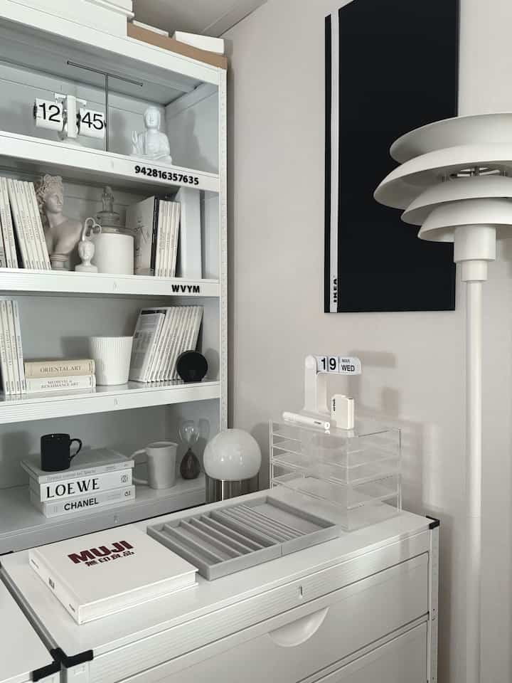 White and monotone study space featuring organized bookshelf and storage ideas with a simple modern interior
