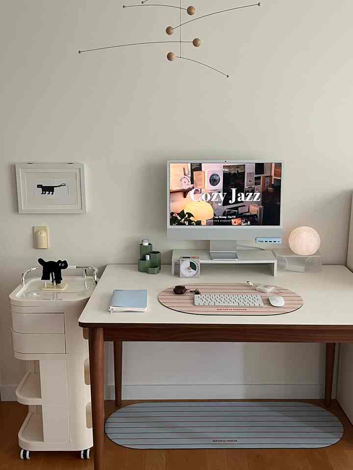 Simple and modern home office in white and wood tones, featuring a desk and a wheeled trolley neatly arranged