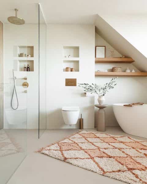 Natural-tone bathroom featuring a beige rug and minimalist white interior creating a cozy atmosphere