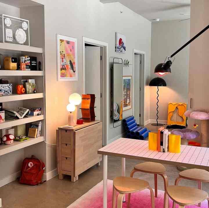 Bright natural-toned dining room featuring a foldable table and cat tower with a simple modern atmosphere