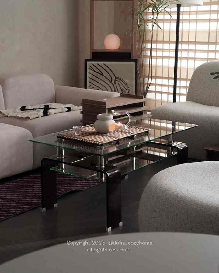 A calm natural-tone living room featuring a glass coffee table and cozy sofas with a simple aesthetic