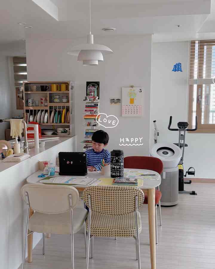 白とナチュラルカラーのダイニング、子供が勉強している落ち着いた雰囲気のある家族空間