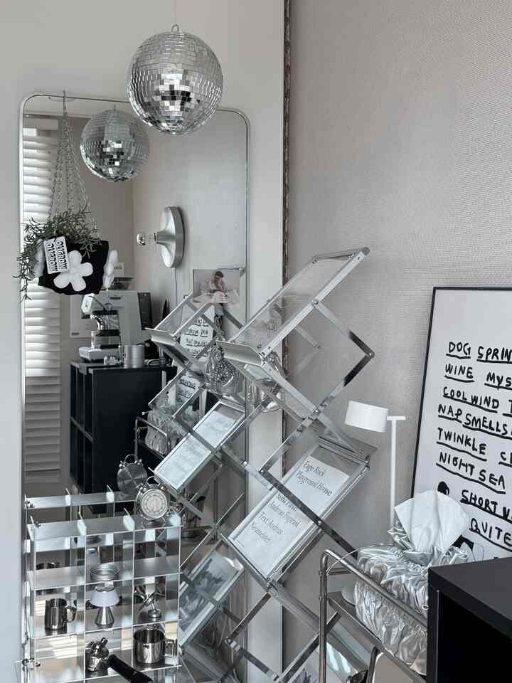 Silver-toned small space featuring disco balls, coffee machine, and stylish storage racks for a trendy home cafe vibe
