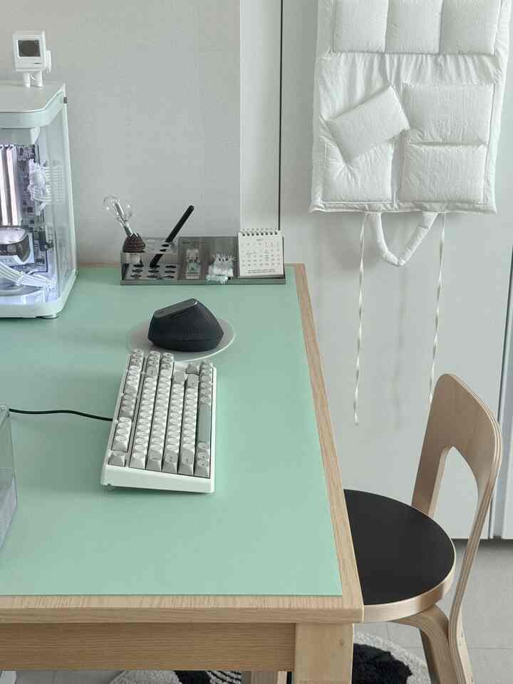Natural-colored compact home office featuring a wooden desk and office chair in a tidy workspace