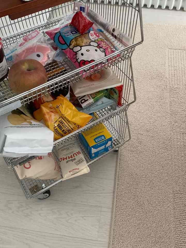 Beige-toned carpet with a silver metal kitchen cart storing various groceries in a tidy space
