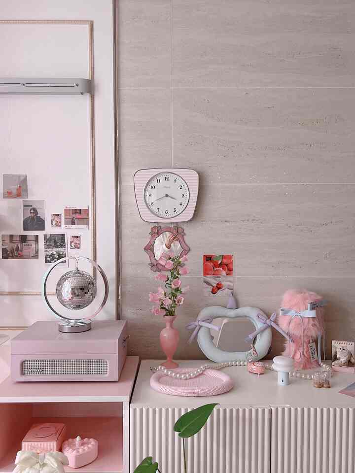 Pink and natural color toned living room featuring vintage style clock, vase with flowers, and charming decorative objets creating cozy atmosphere
