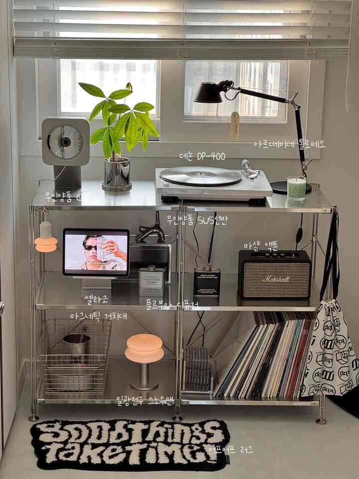 Scandinavian-style small room featuring stainless steel shelving, a turntable, and Marshall speaker with a cozy home cafe vibe