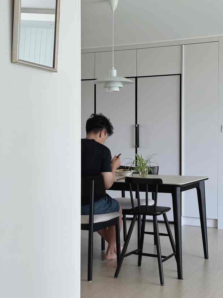 Monotone dining room featuring dining table and chairs in a clean kitchen space