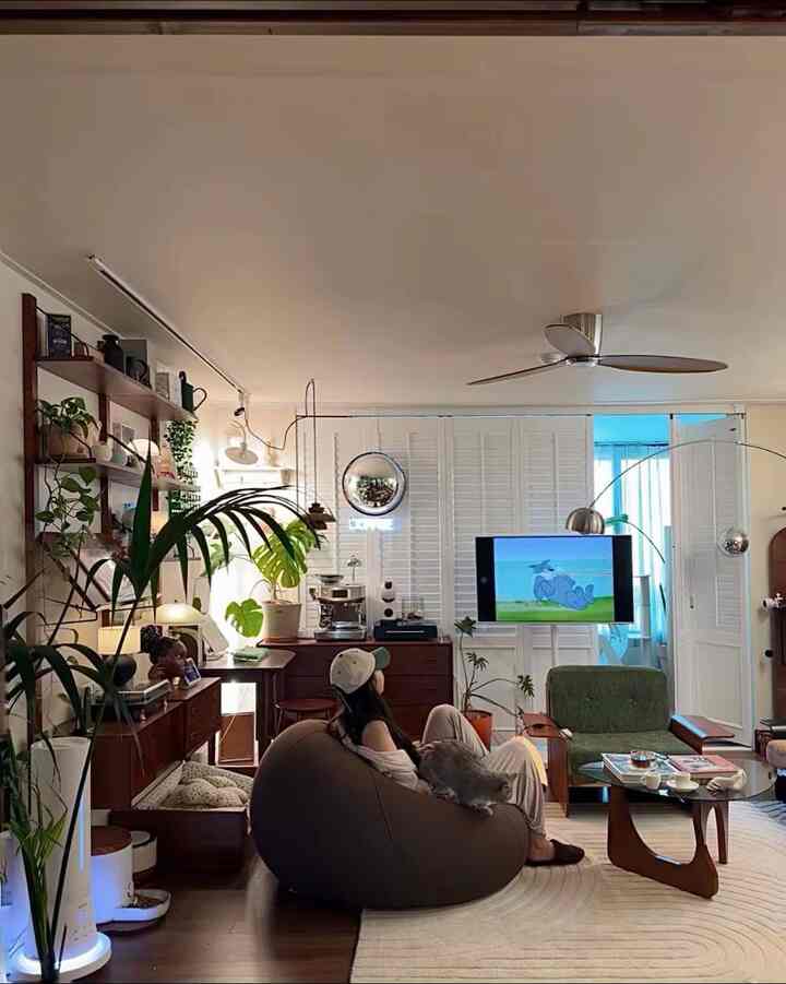 Natural toned living room featuring a large bean bag sofa and green armchair in a cozy atmosphere