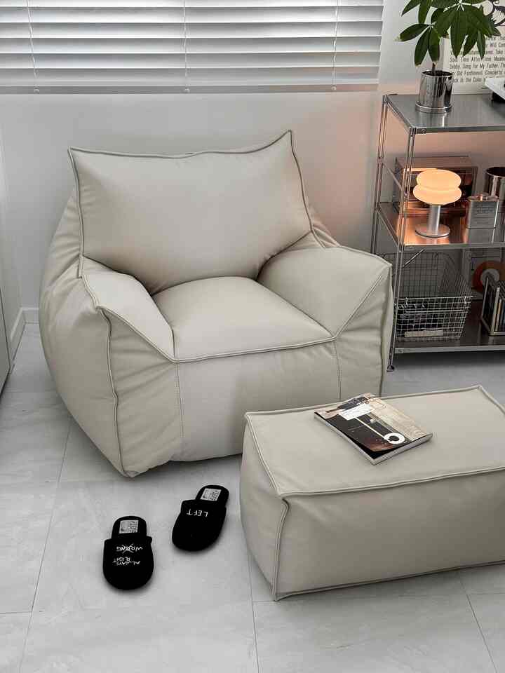 Cozy bean bag and ottoman in soft beige tones within a minimalist modern home office space
