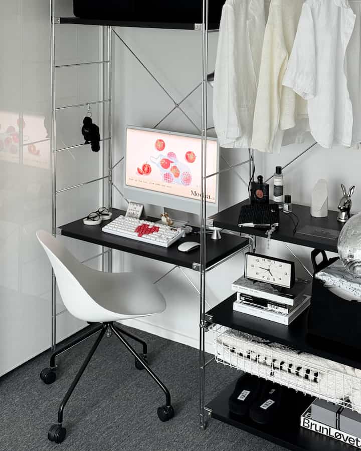 Black and white toned home office featuring a compact desk and office chair in a neat workspace