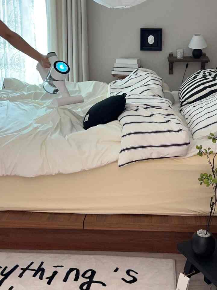 白とナチュラルトーンの寝室、大きなベッドと整った寝具が落ち着いた雰囲気を醸し出す空間