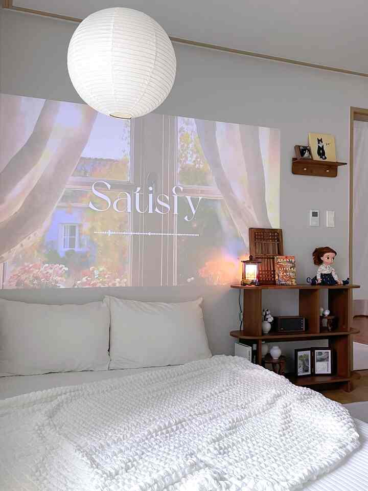 白と木目調が調和した寝室、ウォールナットの壁棚とプロジェクターが配置された雰囲気のあるインテリア