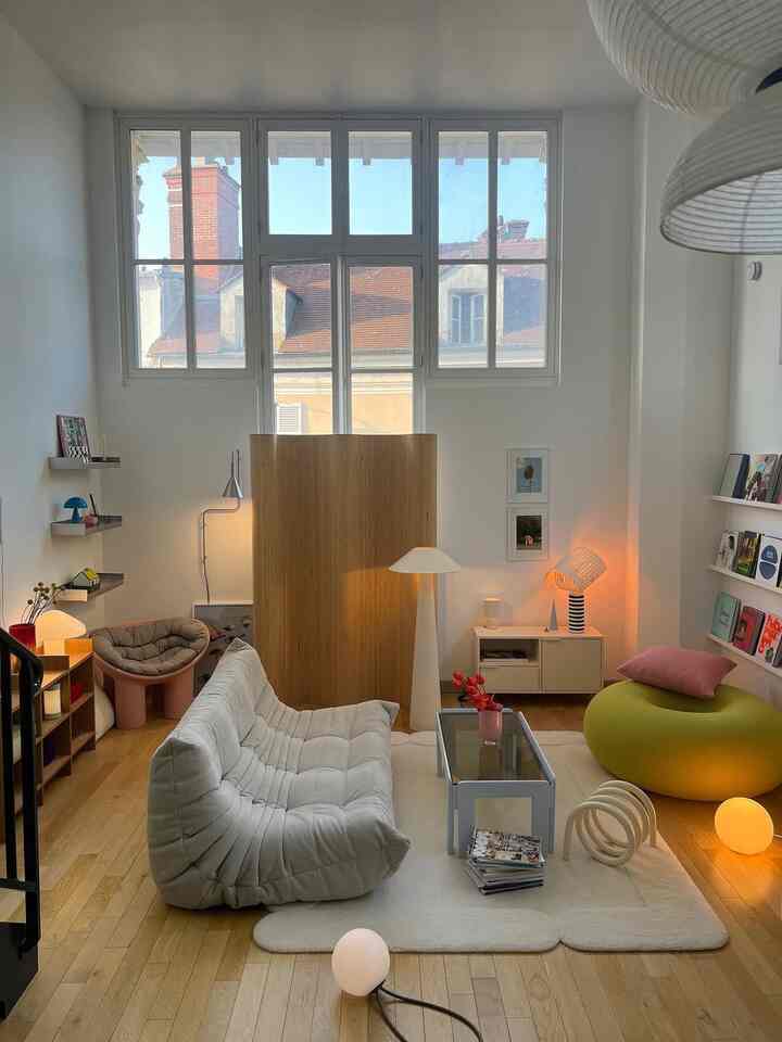 White and wood tone loft living room with comfortable sofa and lighting, featuring modern natural interior design