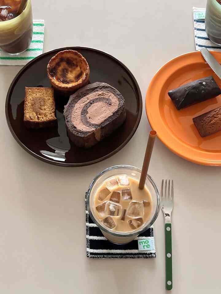 Light beige toned home cafe scene featuring coasters and cake plates with a cute table setting