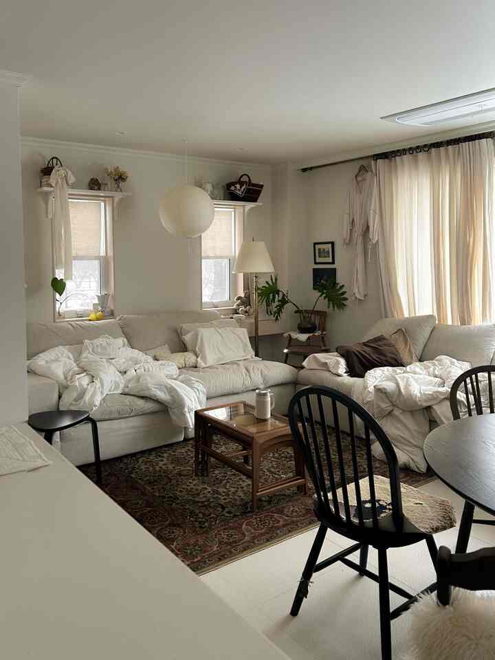 Beige and wood tone two-person living room featuring natural sofas and a patterned rug with cozy atmosphere