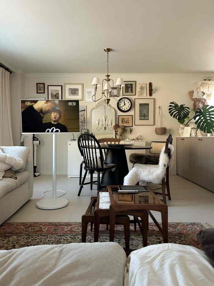 Natural-toned living and dining room featuring rattan chairs and wooden tables with a modern cozy atmosphere
