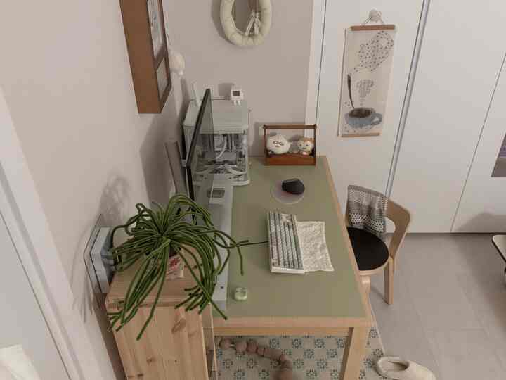 白い壁と木目調家具、緑のデスクが配置されたコンパクトなワンルームのホームオフィス空間