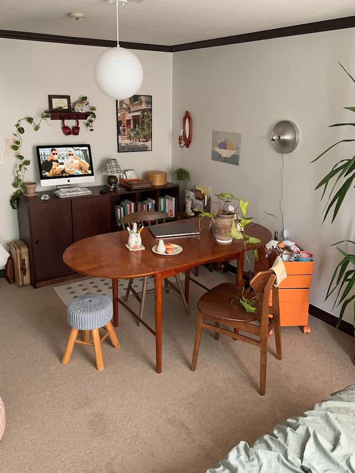 木目調とベージュの書斎、オレンジの収納ワゴンがアクセントの自然な雰囲気のインテリア