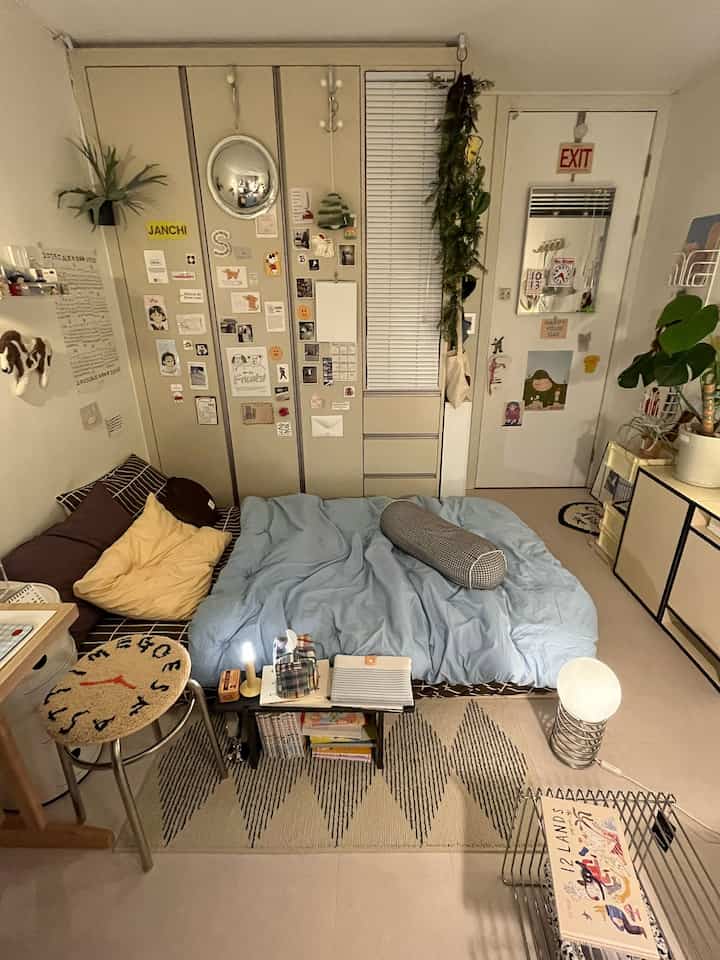 Small bedroom with brown and sky blue tones featuring a mattress and built-in closet creating a cozy atmosphere